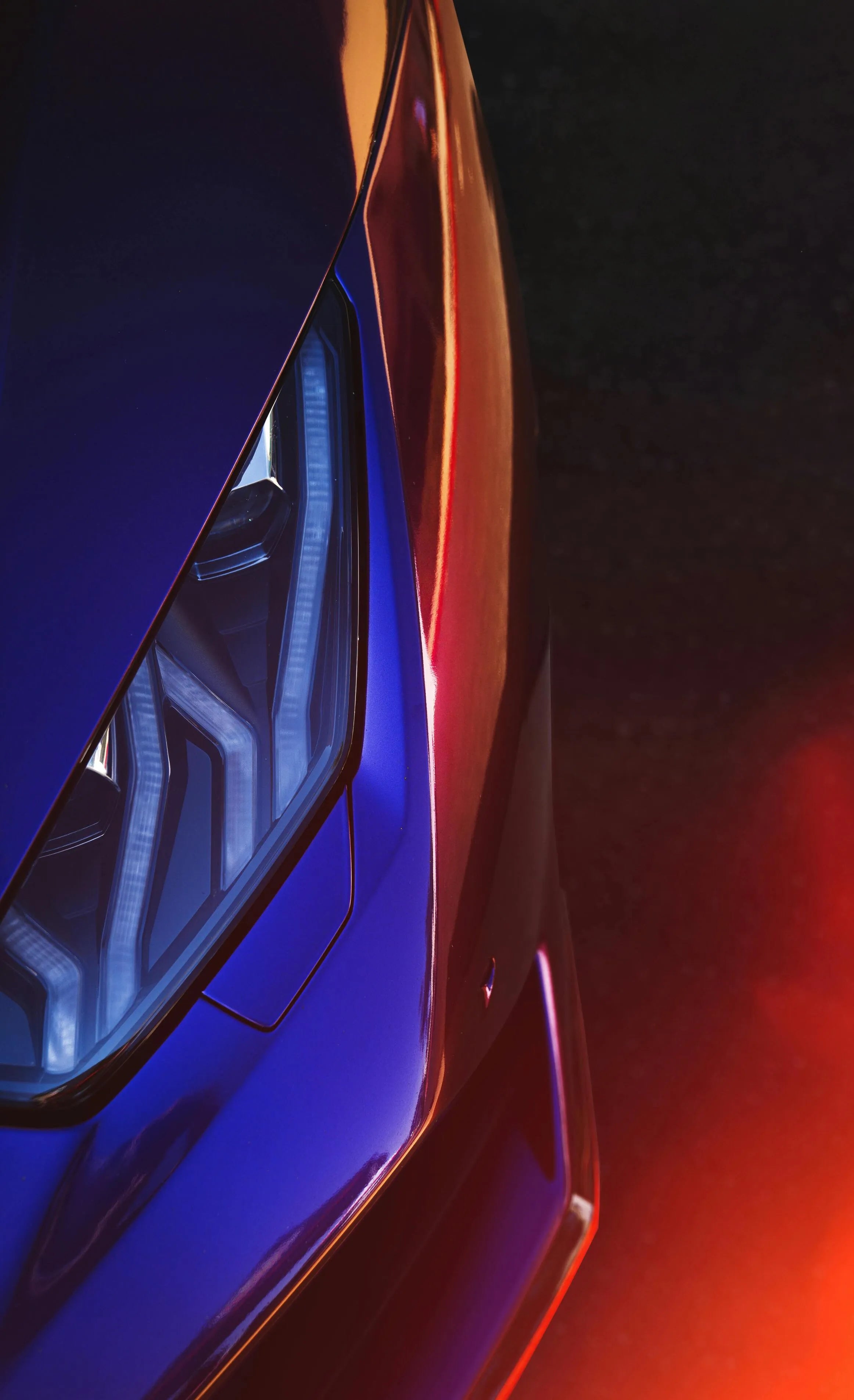 Close-up of a car's headlight with a dark background