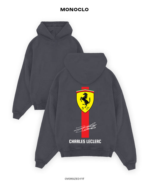 Gray hoodie with Ferrari logo and Charles Leclerc name on the back, brand 'Monoclo' visible.